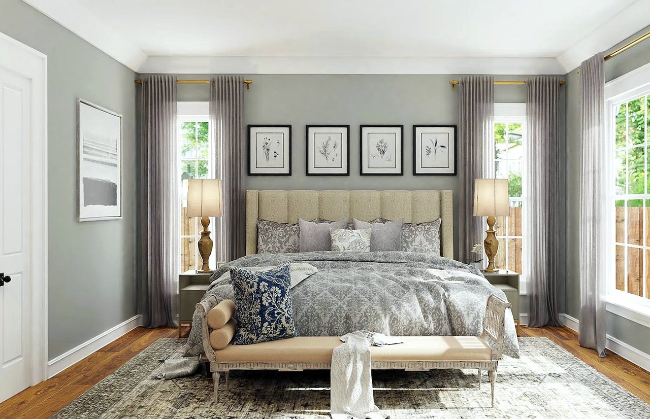 A grey bedroom with framed botanical prints and tall windows on two sides